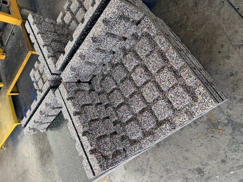 Comparison showing a salt-stained rubber tile next to a deep-cleaned tile